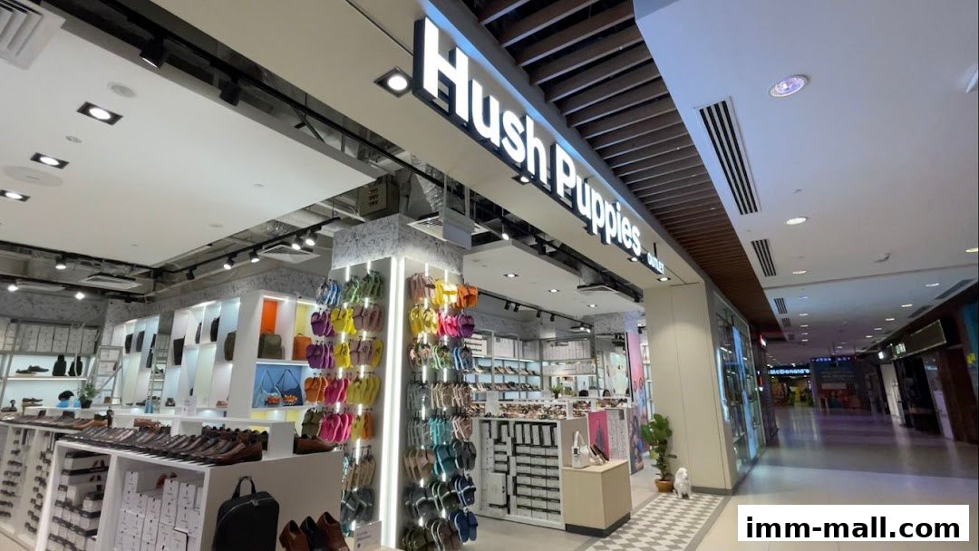 The entrance of a Hush Puppies Footwear & Bags Outlet store, showcasing a wide variety of footwear and bags.