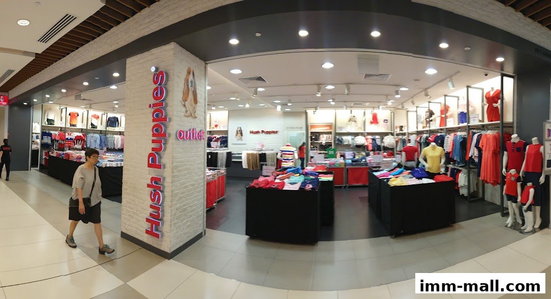 Interior view of a Hush Puppies outlet store showcasing clothing and accessories.