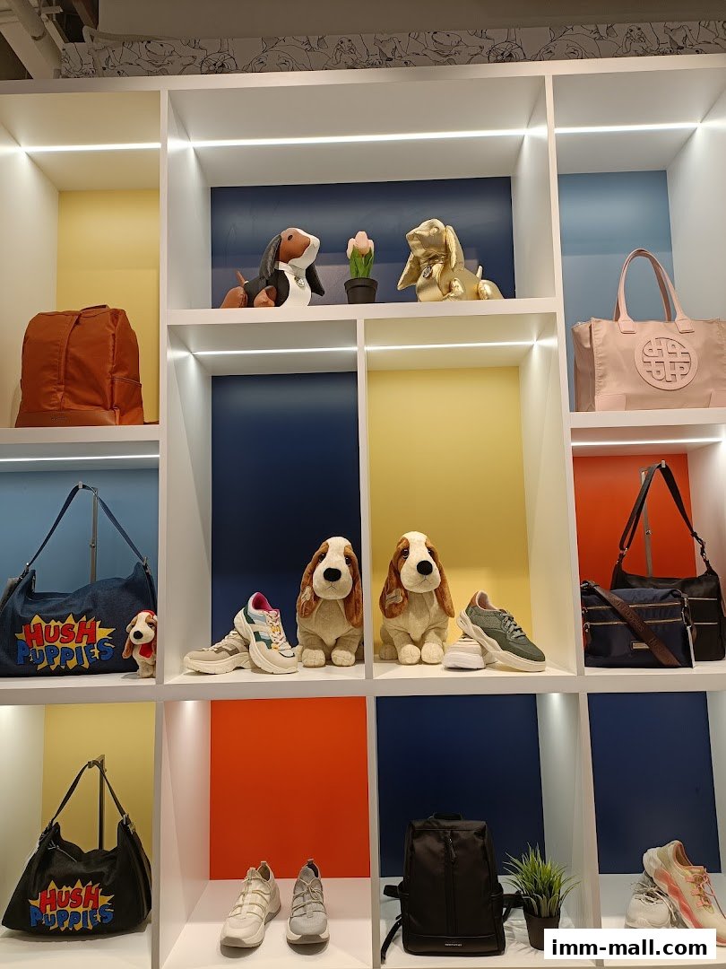 Hush Puppies store display featuring shoes, bags, and plush dog toys.