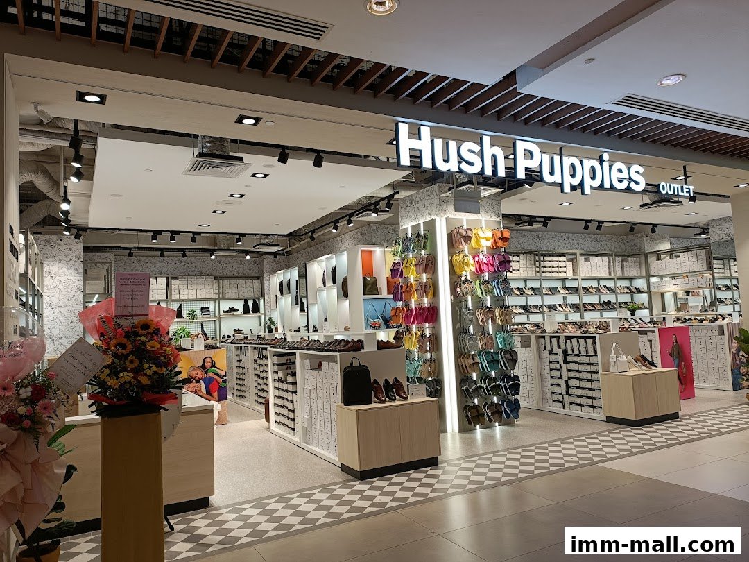 Hush Puppies Outlet store showcasing a wide variety of footwear and bags.