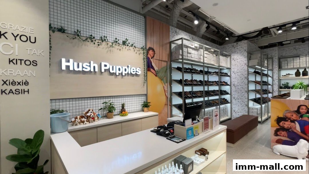 Interior view of a Hush Puppies store showcasing shoes and bags on display shelves.