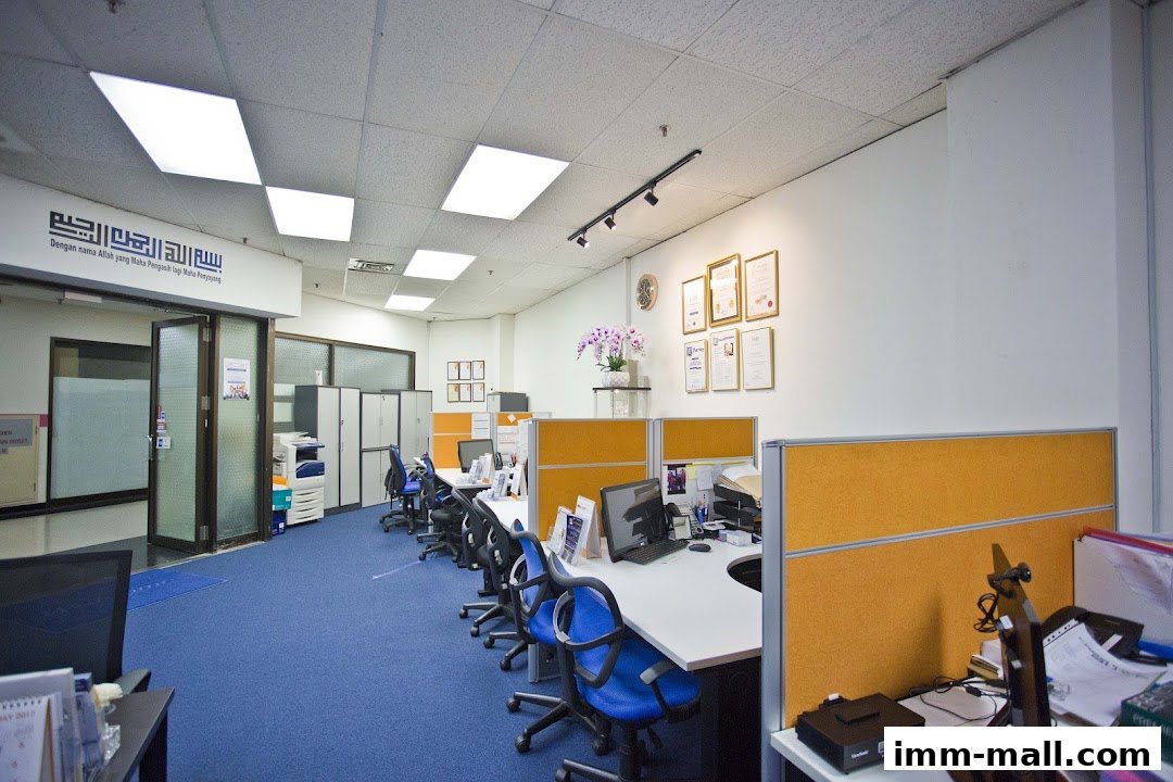 An office interior with cubicles, desks, chairs, and a printer.