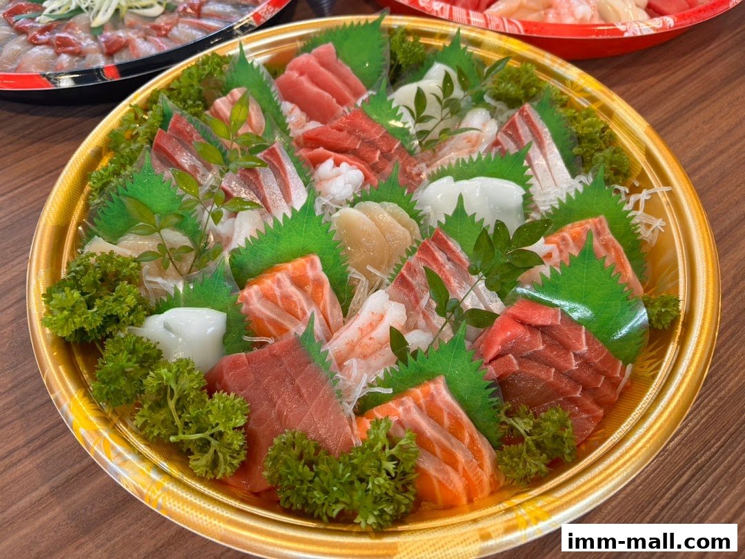 A platter of assorted sashimi, including salmon, tuna, and white fish, garnished with parsley and decorative leaves.