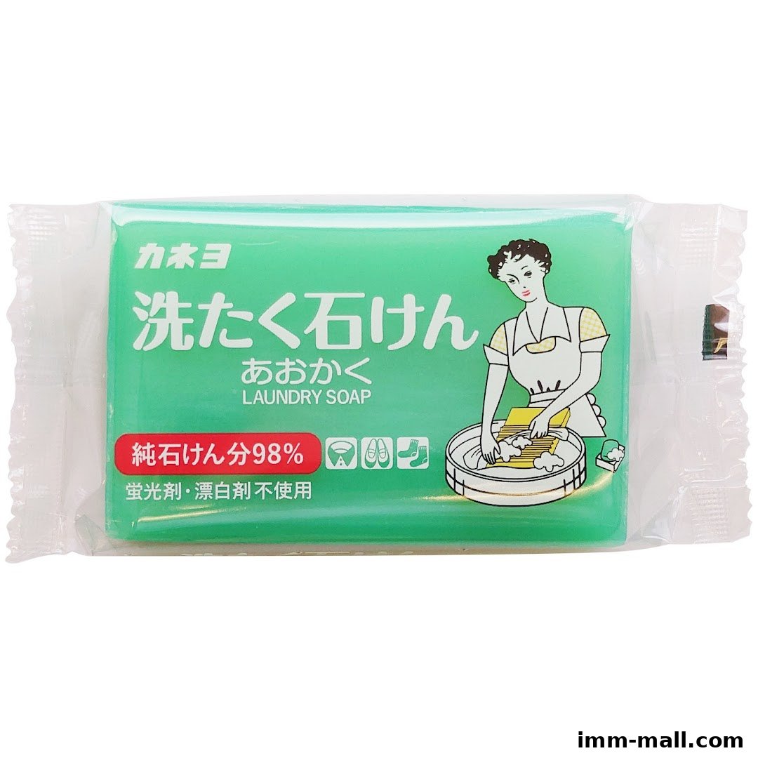 A bar of green laundry soap with Japanese text and an illustration of a woman washing clothes.