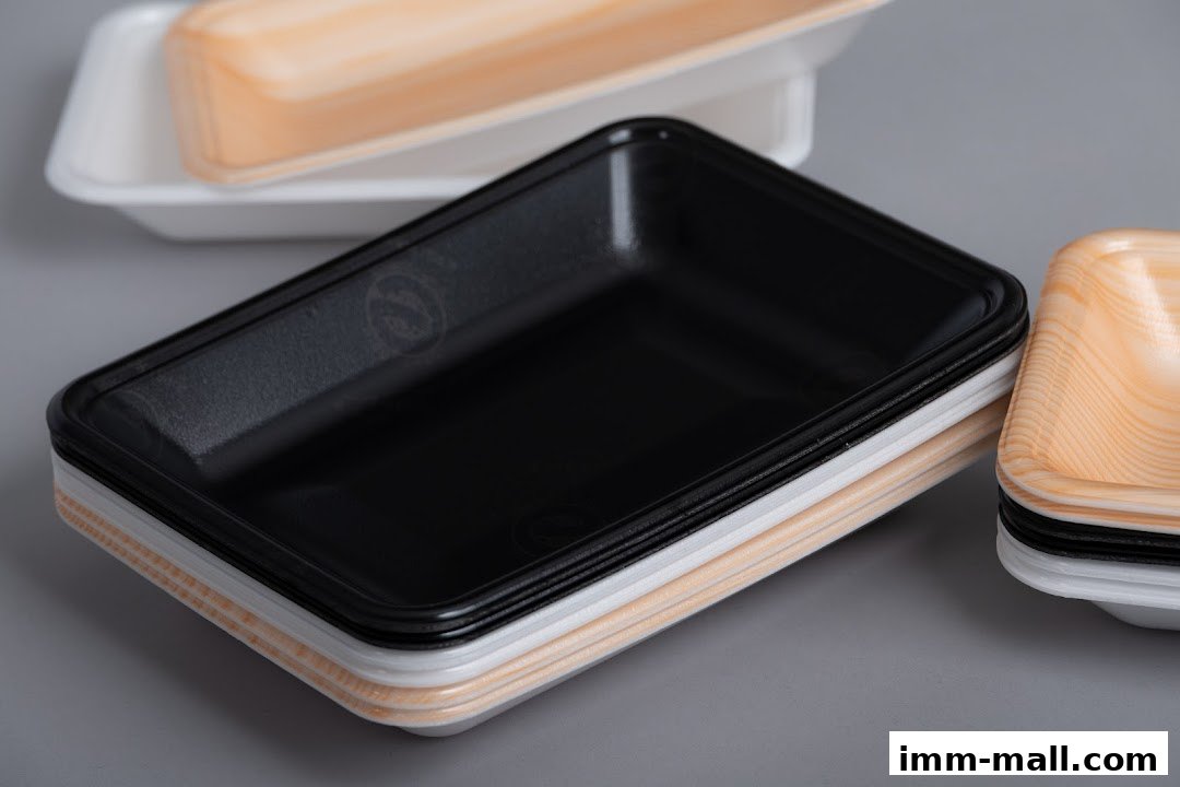 A stack of various colored food containers, including black, white, and wood-grain patterned.