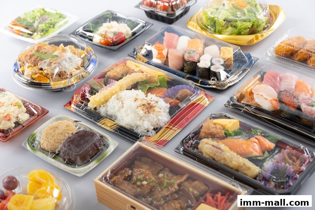 A variety of Japanese bento boxes, sushi, and salads in clear plastic packaging.
