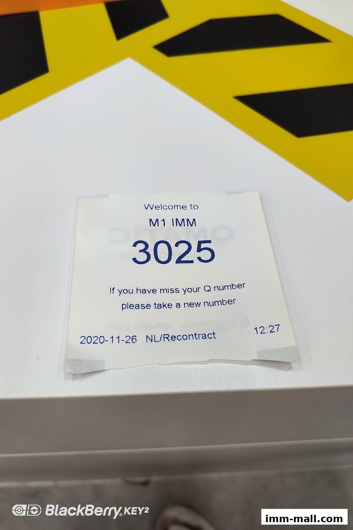 A queue number ticket from M1 IMM, a phone shop and internet service provider.