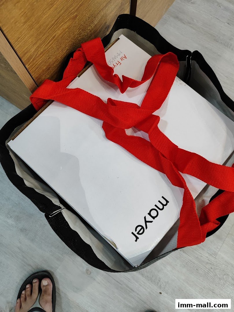 A shopping bag with a red ribbon holds a white box with 'Mayer' and 'Air Fry' branding.