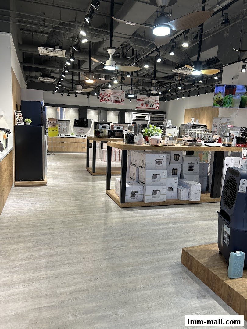 Interior view of a well-lit appliance showroom with various home appliances on display.