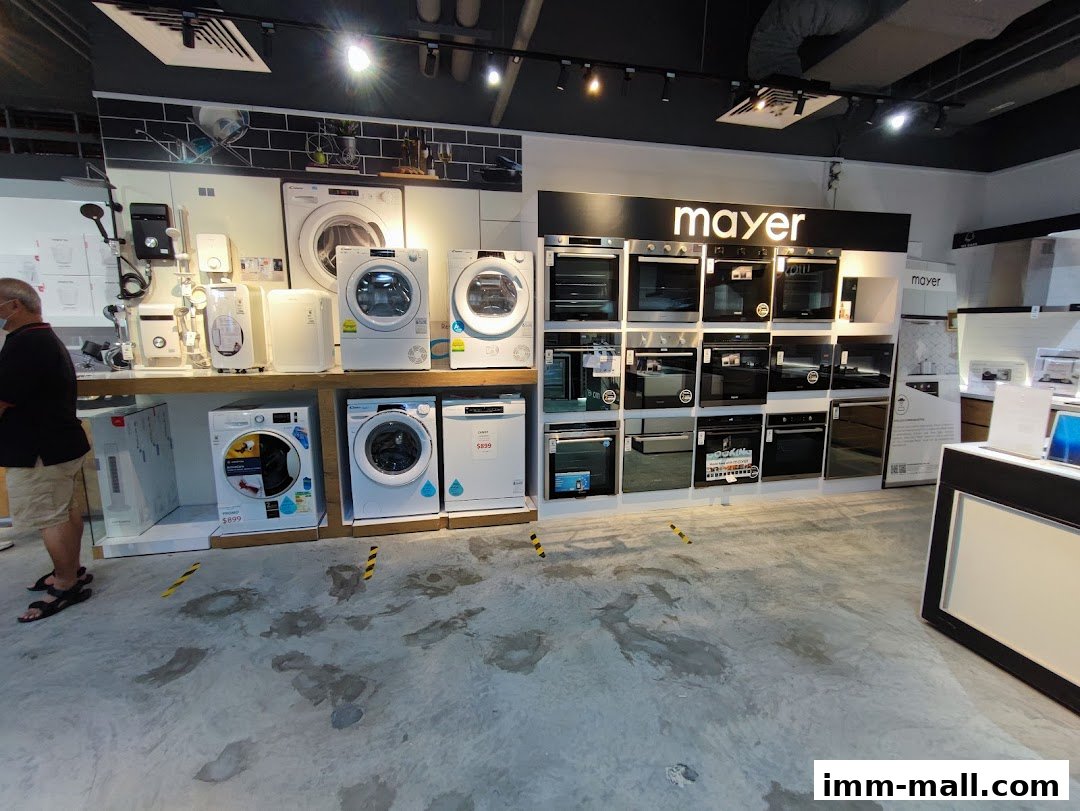 Interior view of a Mayer showroom displaying various home appliances like washing machines and ovens.