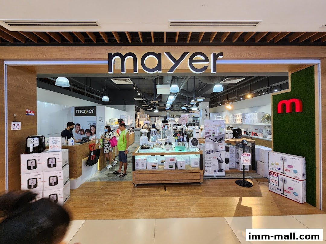 The entrance of the Mayer Showroom IMM Building, showcasing various home appliances and a sale display.
