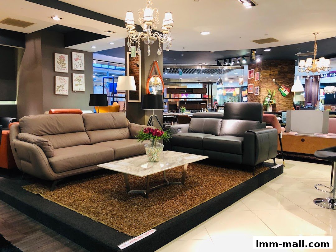 A furniture store display featuring two stylish sofas and a coffee table with floral arrangement.
