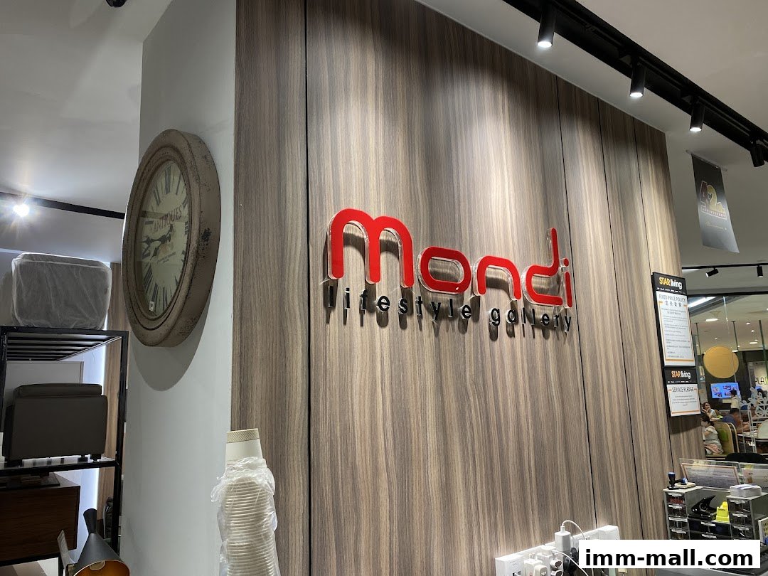 The Mondi Lifestyle Gallery shop sign with a vintage clock and furniture in the background.