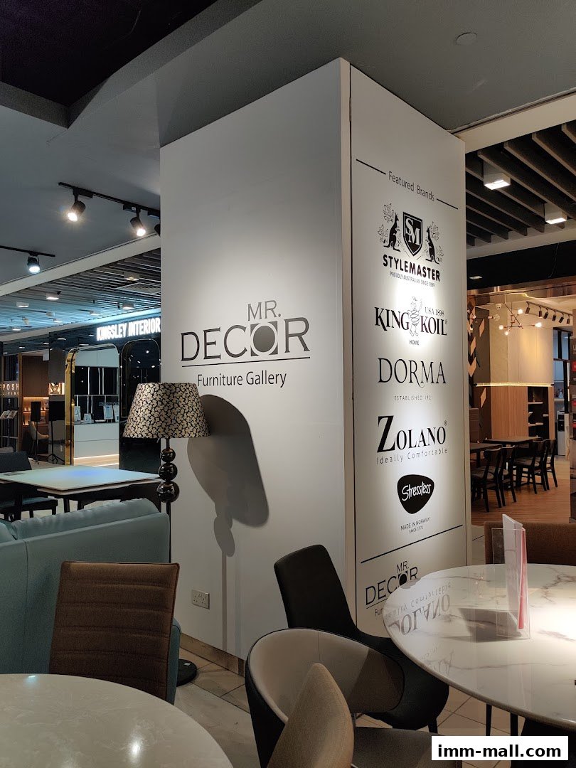 Interior of a furniture gallery showcasing various seating options and featured brands.