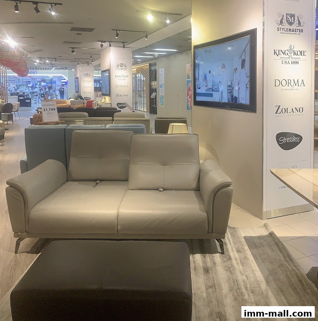 Interior view of a furniture store showcasing sofas and various brands on display.