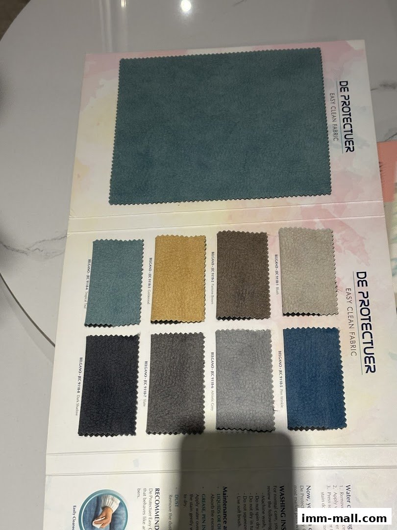 A swatch book showcasing various colors and textures of easy-clean fabric.