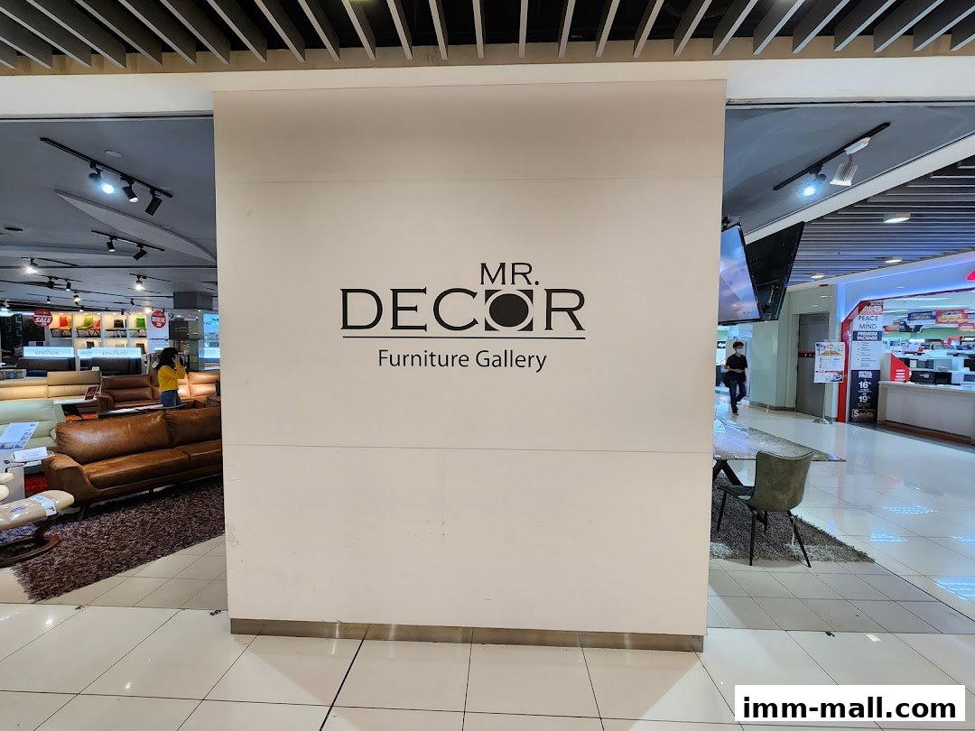 Interior view of Mr. Decor Furniture Gallery showcasing sofas and chairs with the store's logo.
