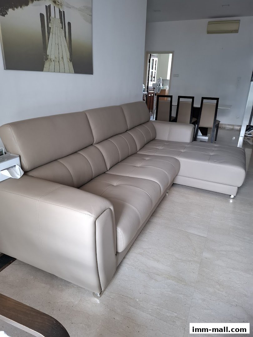 A spacious, modern sectional sofa in a light beige color, displayed in a well-lit room.