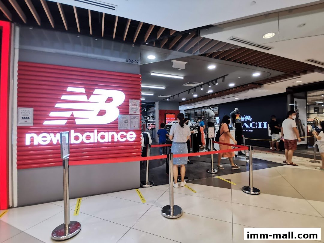 The New Balance store entrance with a queue and other shoppers inside.