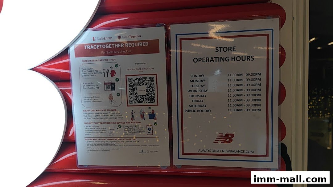 New Balance store operating hours and SafeEntry instructions displayed on a window.