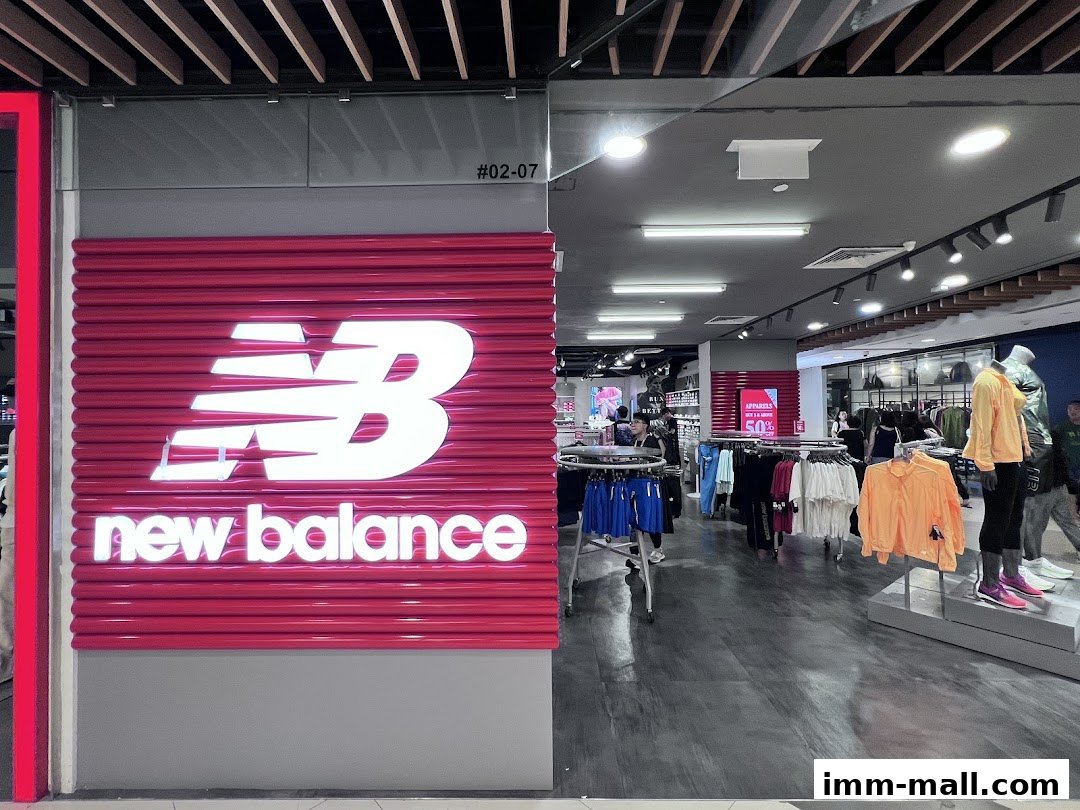The New Balance Premium Factory Outlet storefront with its iconic logo and a view of the store's interior.