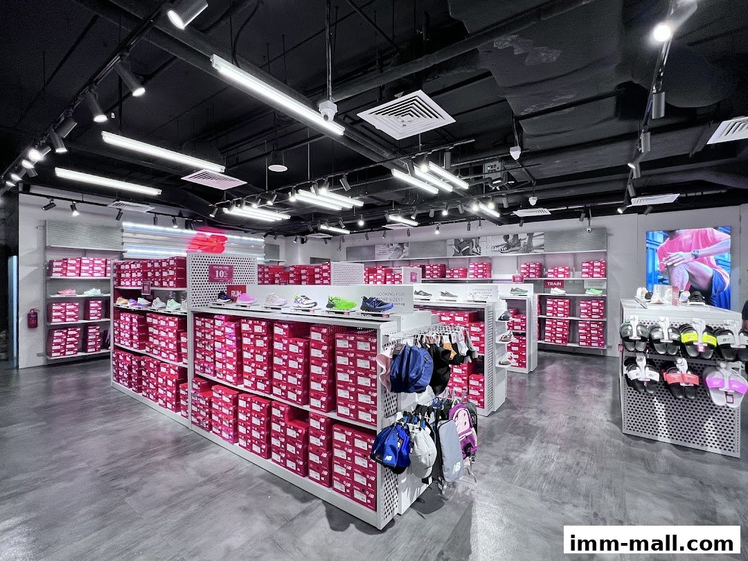 Interior view of a New Balance factory outlet store showcasing rows of shoe boxes and display shelves.