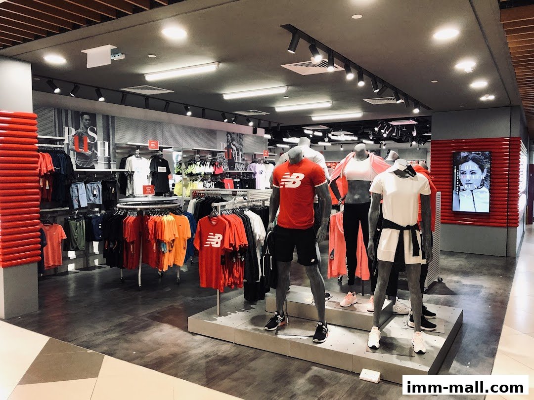 Interior view of a New Balance store showcasing athletic apparel on mannequins and racks.