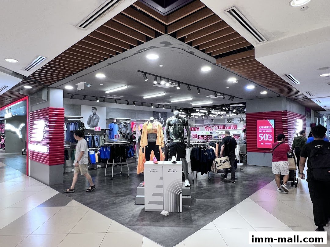 Interior view of a New Balance store with apparel and mannequins on display.