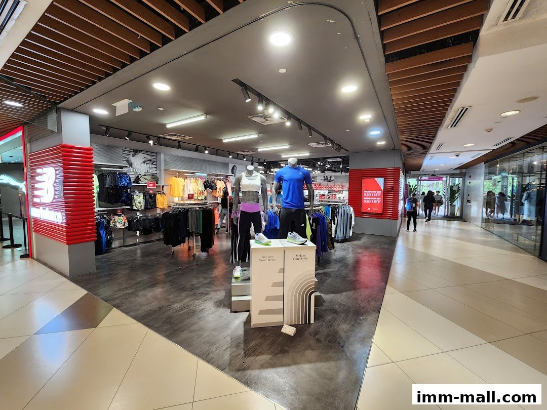 Interior view of a New Balance store showcasing athletic apparel and mannequins.