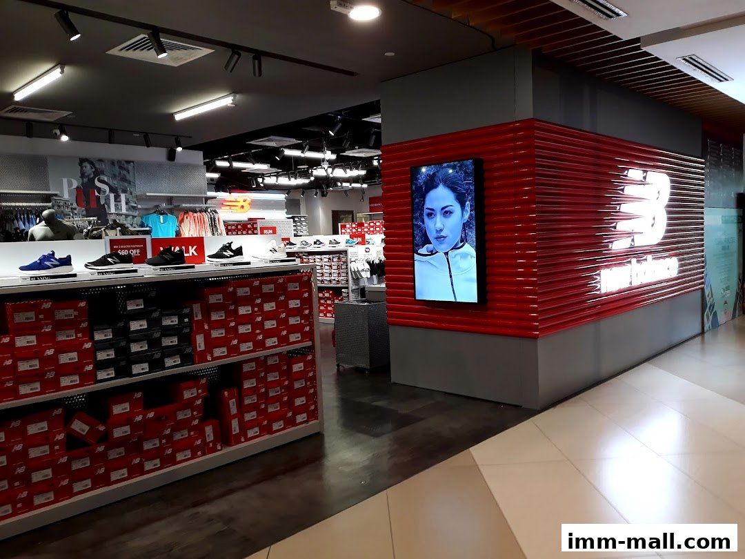Interior view of a New Balance store showcasing shoes, apparel, and branding.
