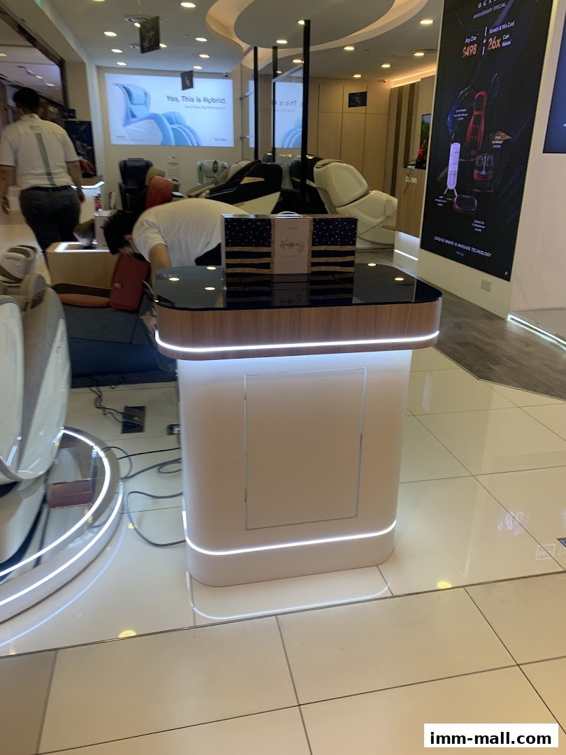 OGAWA shop interior with massage chairs and promotional displays.