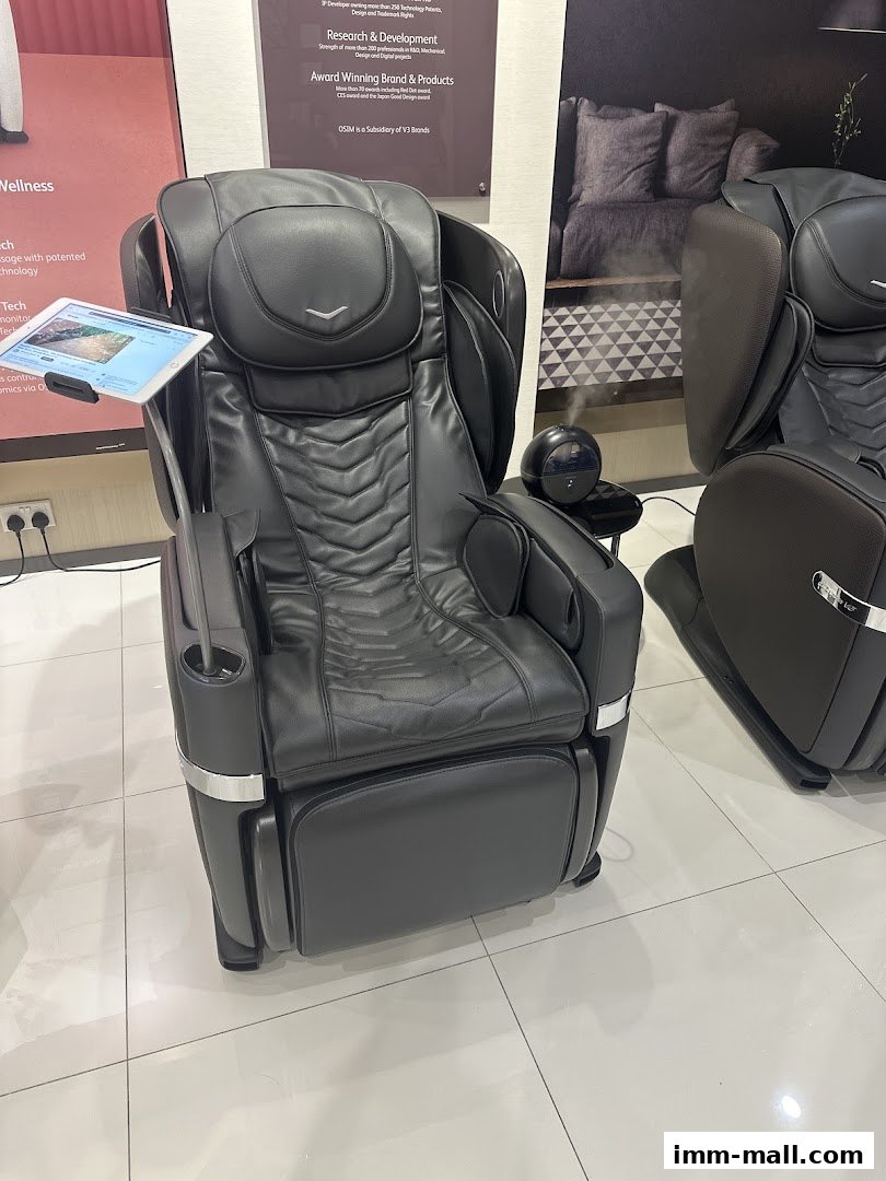A black OGAWA massage chair with a tablet attached, showcasing its features.