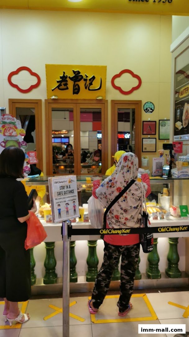 Customers queue at Old Chang Kee, a popular snack shop, with social distancing markers.
