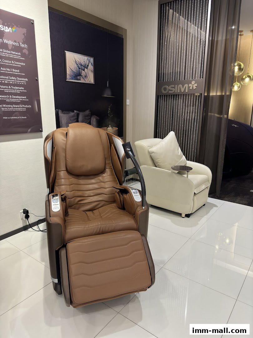 A brown OSIM massage chair is displayed in a modern retail store with another chair in the background.