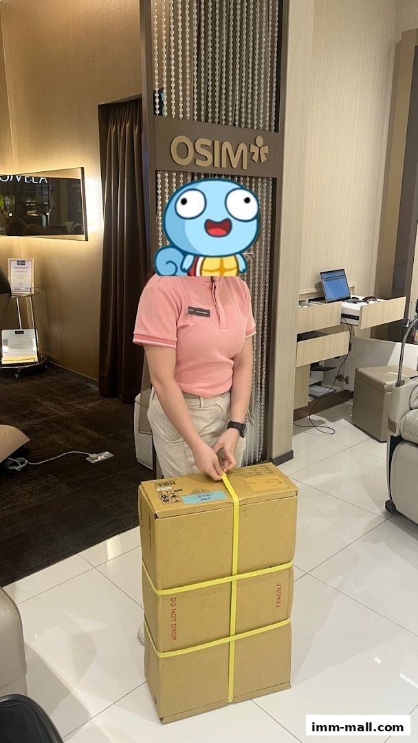An OSIM store employee is securing a stack of boxes with yellow straps.