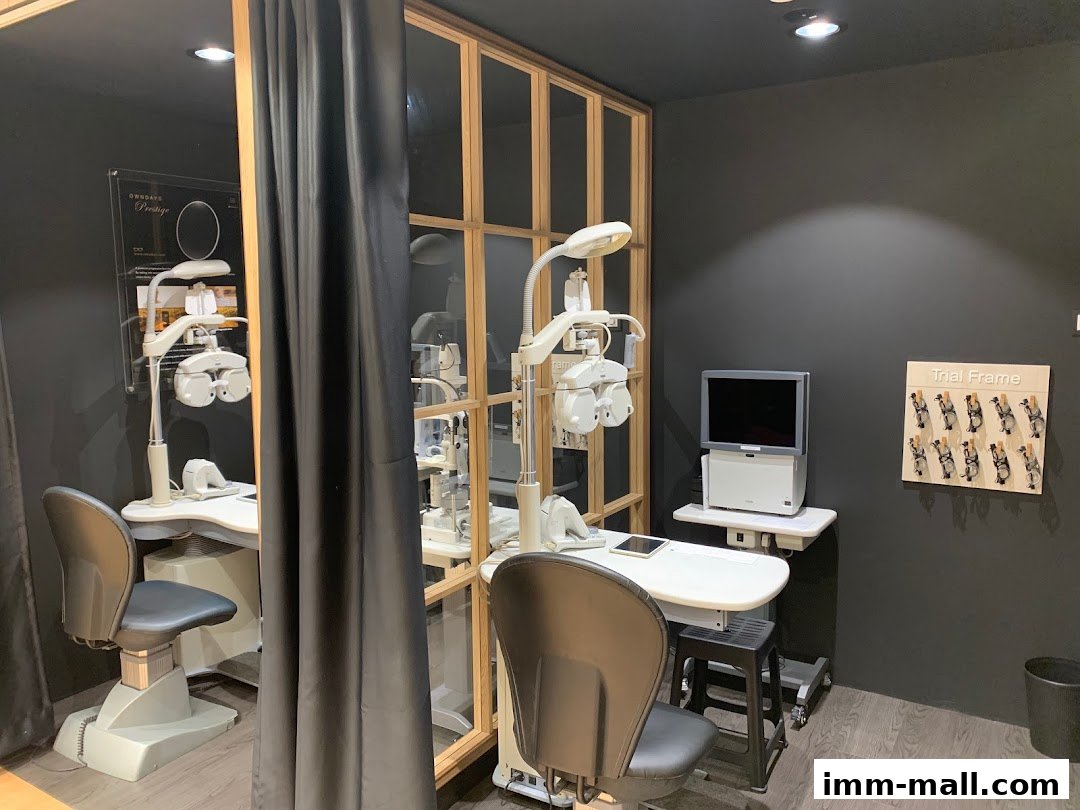 Interior view of an optical shop with eye examination equipment and trial frames.