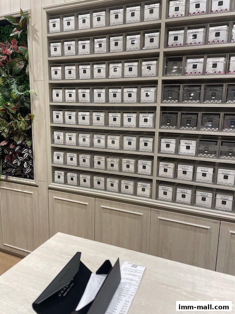 Interior shot of an OWNDAYS store showcasing shelves filled with eyewear cases and a receipt on a counter.