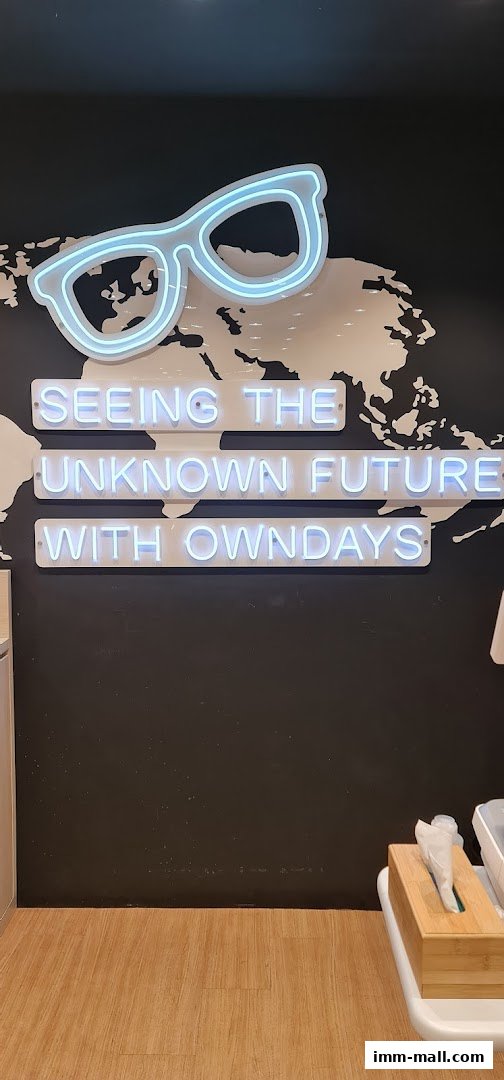 Neon glasses and text on a wall with a world map background.