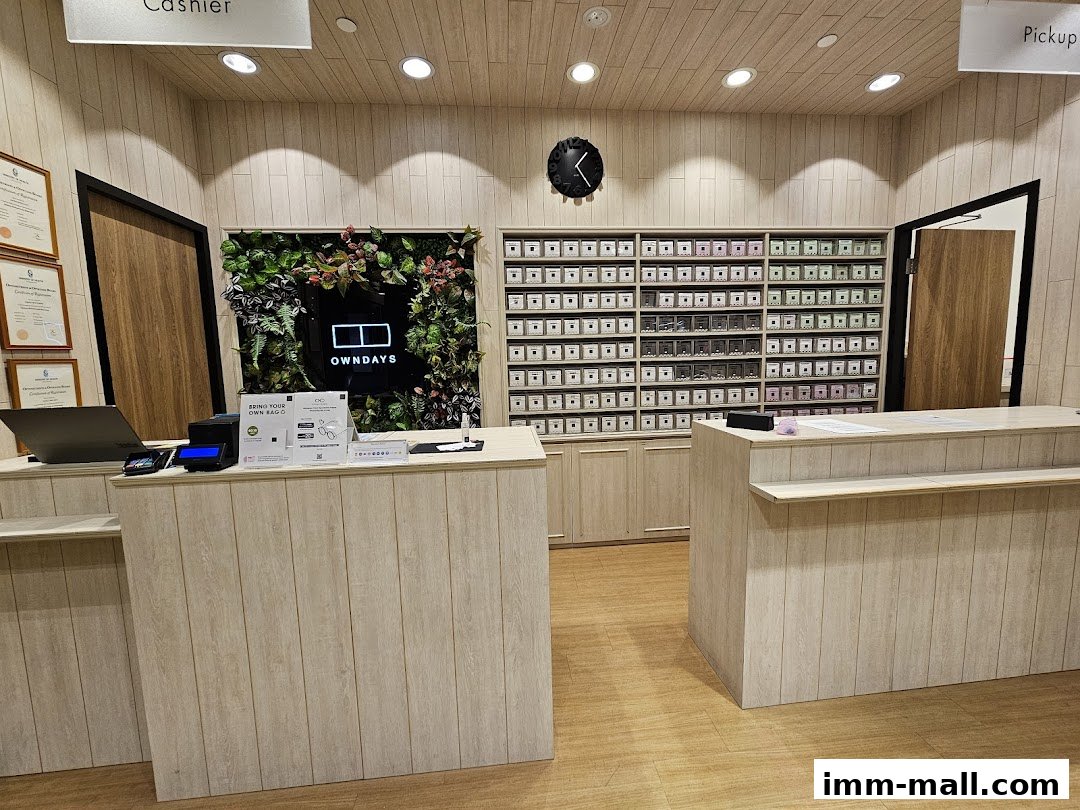 Interior of an OWNDAYS optical shop with a cashier counter and shelves of eyewear.