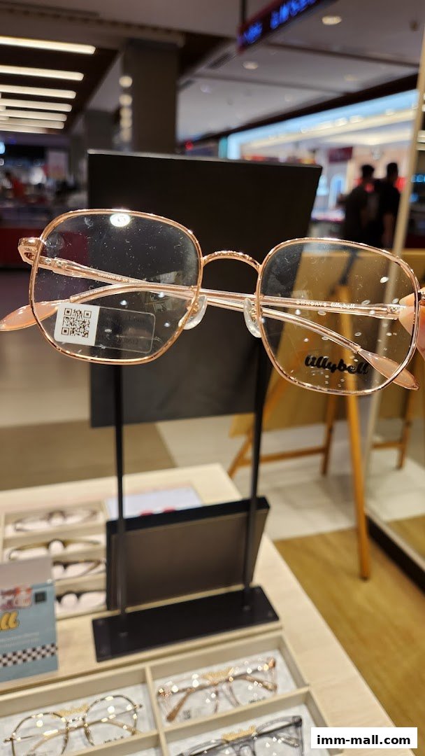 A close-up shot of stylish rose gold eyeglasses with a QR code on the lens.