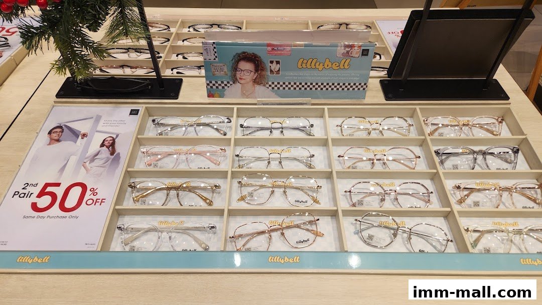 A display of various eyeglasses with a promotional sign for a 50% off second pair.