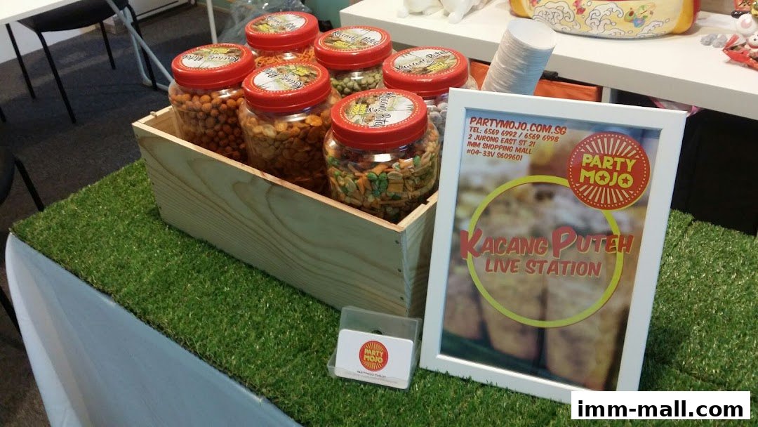 A display of assorted snacks in jars at a live station event setup.