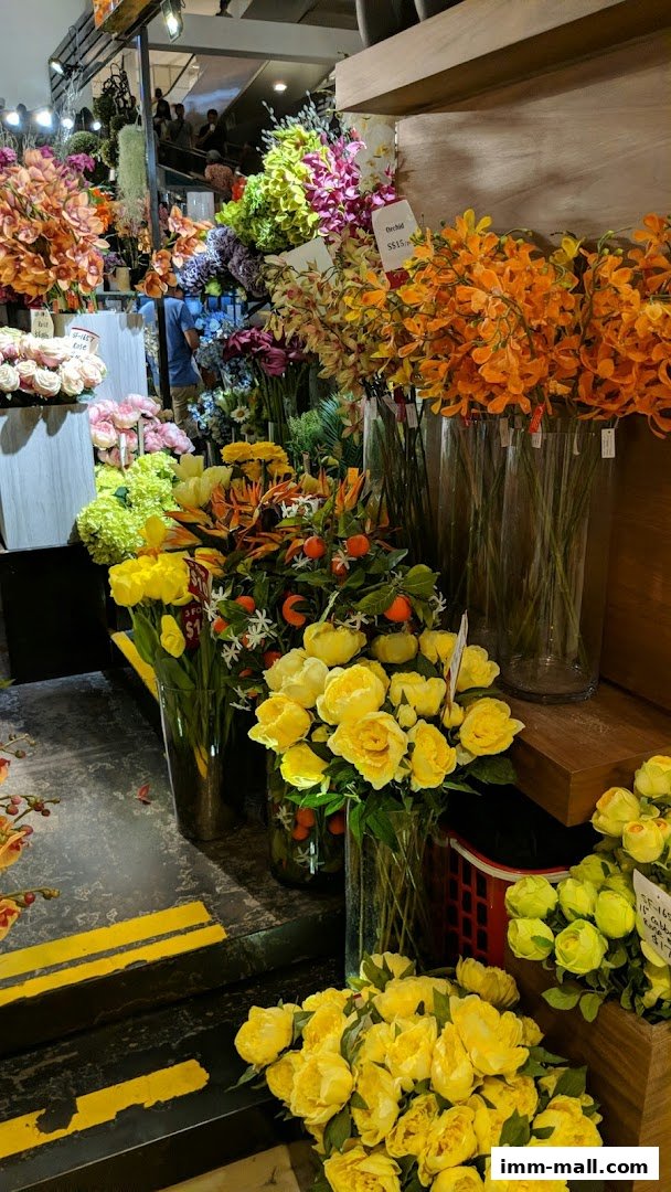 A vibrant display of artificial flowers in various colors and arrangements.