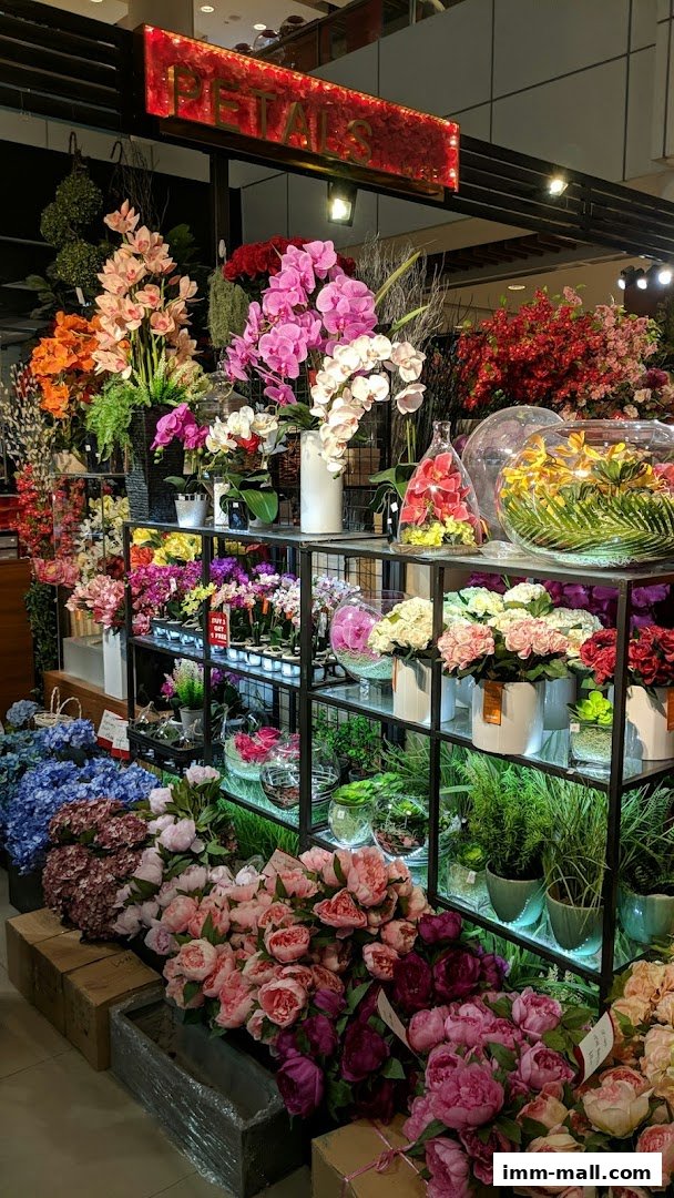 A vibrant display of artificial flowers and plants in various colors and arrangements.