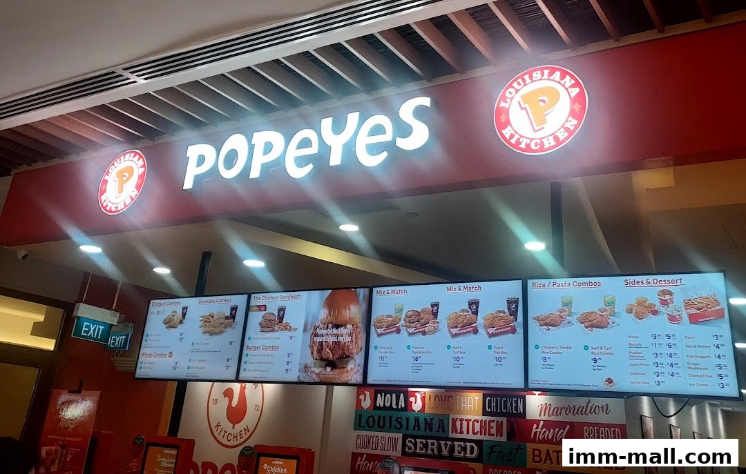 A digital menu board displaying various Popeyes Louisiana Kitchen chicken combos, sandwiches, and sides.