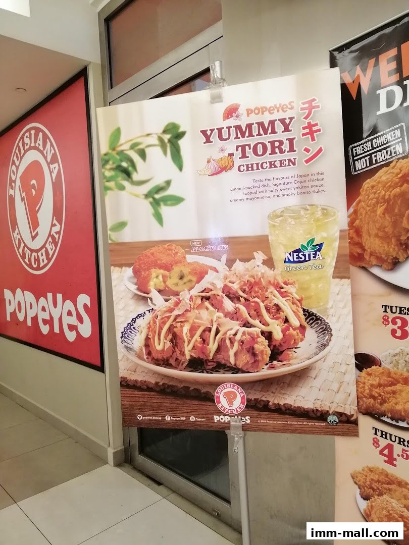 A promotional poster for Popeyes Yummy Tori Chicken with a drink and jalapeno bites.