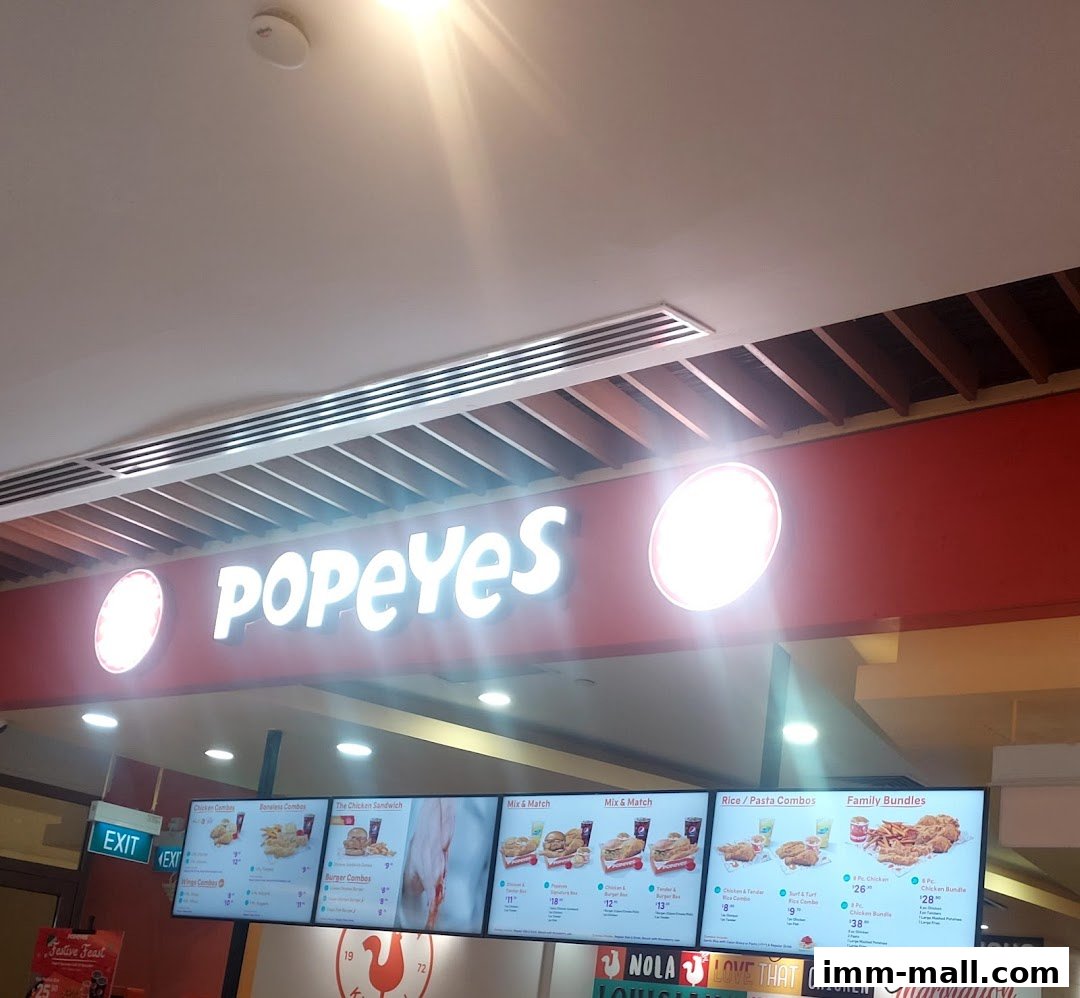 A digital menu board displaying various Popeyes chicken combos, sandwiches, and family bundles.