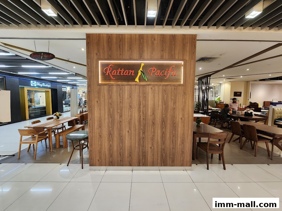 Rattan Pacific furniture store interior with wooden tables, chairs, and displays.