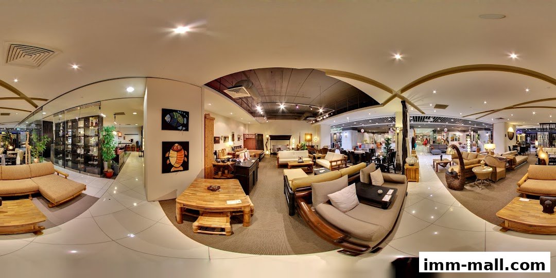 Interior view of a furniture store showcasing various rattan and wooden furniture sets.