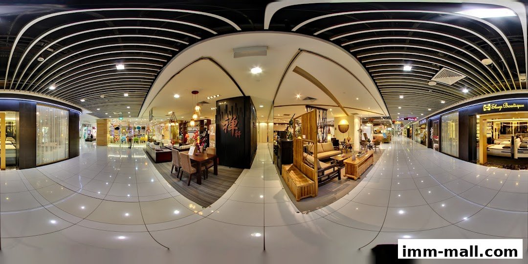 Interior view of a shopping mall corridor showcasing various retail stores and their displays.